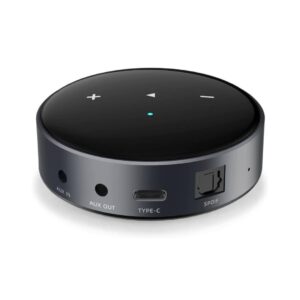 1. A black network Audio streamer with a remote control placed on top, showcasing a modern audio setup.
