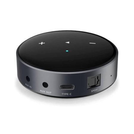1. A black network Audio streamer with a remote control placed on top, showcasing a modern audio setup.