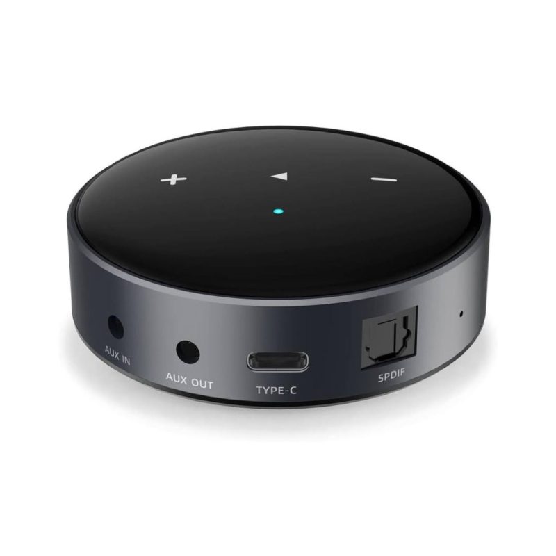 1. A black network Audio streamer with a remote control placed on top, showcasing a modern audio setup.
