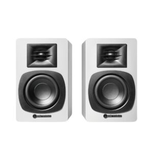 White Audio-Technica AT-SP3X powered bookshelf speakers positioned on a shelf, showcasing their sleek design and modern aesthetics.